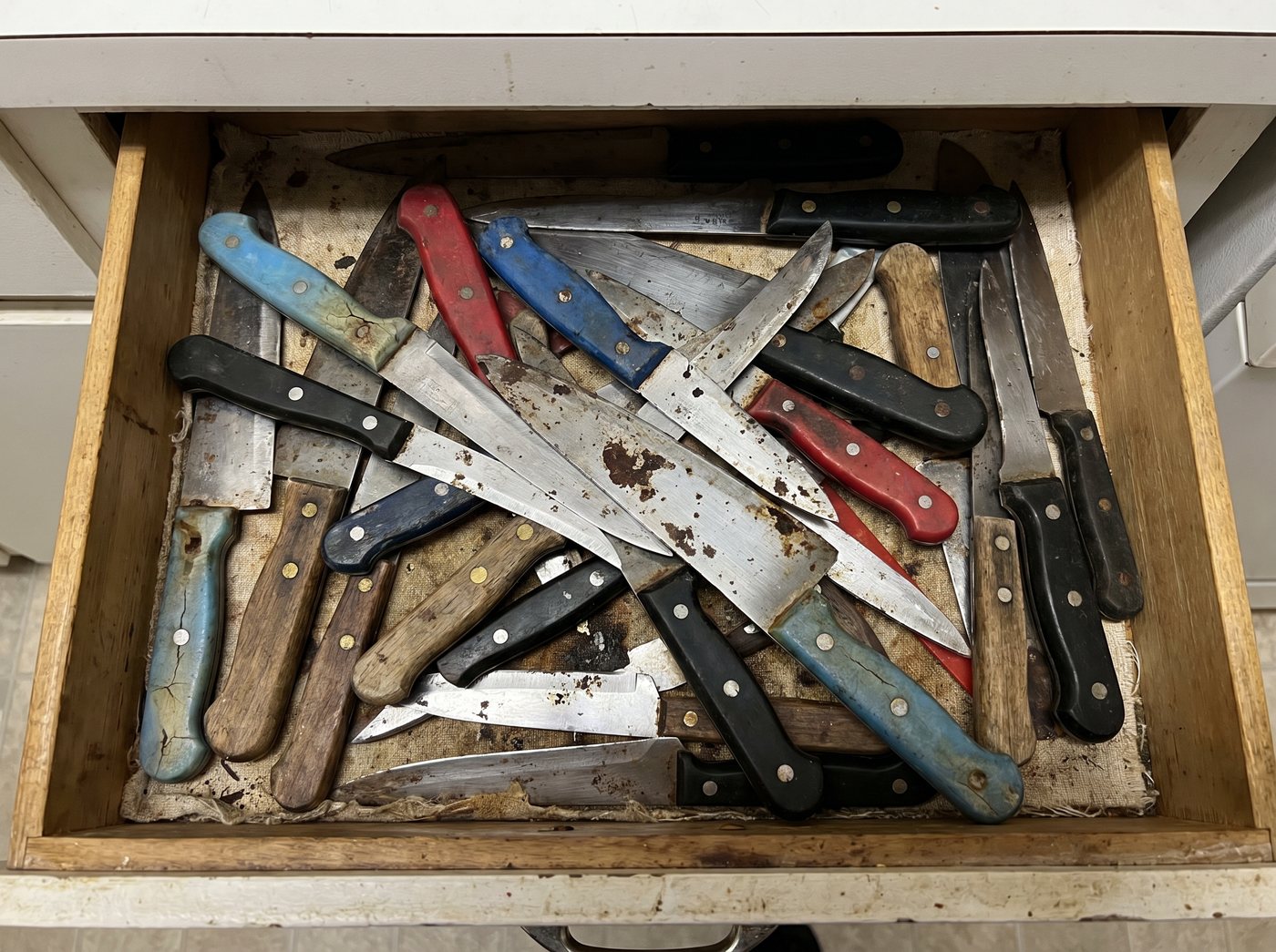 Drawer of old rusty knives
