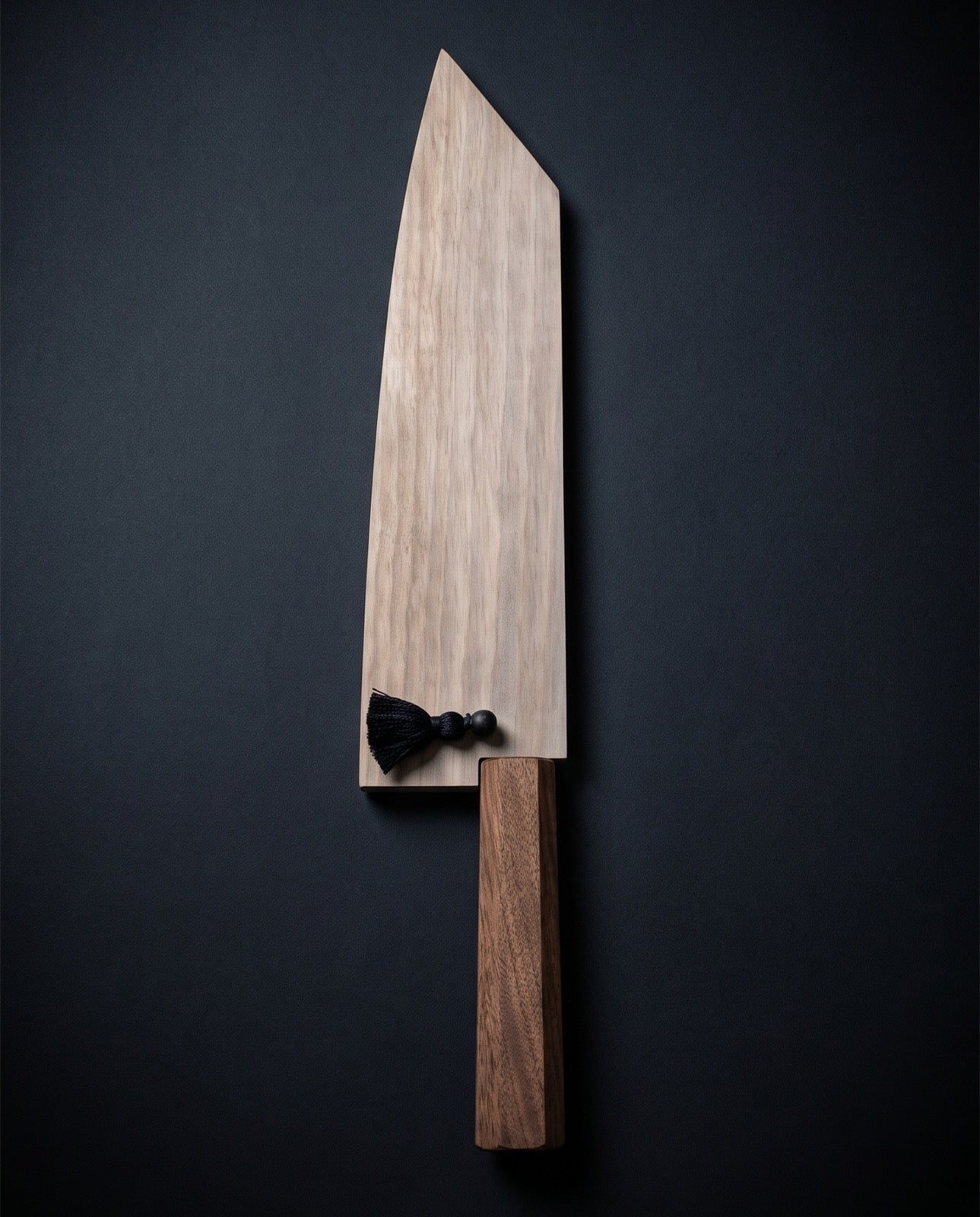 Osantoku knife resting in its walnut saya sheath